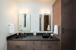 The primary bedroom ensuite has a double vanity with beautiful modern fixtures.